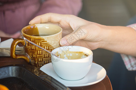 早上女人手握着一杯咖啡热咖啡背景图片