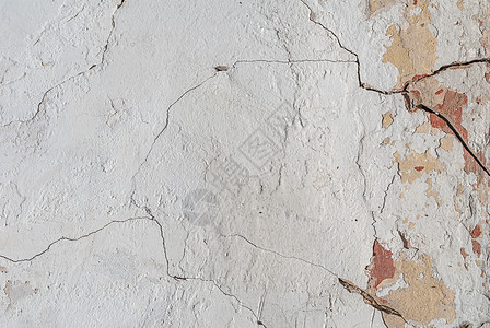 混凝土墙上的旧碎石膏 老混凝土墙的裂缝 背景纹理象牙石头建筑黄色灰色褐色棕褐色合金白色水泥图片