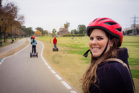 一群人在公园的Segway旅行车轮司机沥青天气运输车娱乐吸引力乐趣机器车辆图片