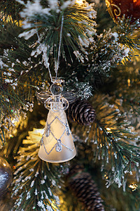 圣诞树上的玻璃天使松树白色橙子装饰品季节性背景图片