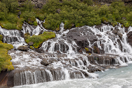 瀑布冰岛流动蓝色溪流绿色跑步瀑布火山荒野图片