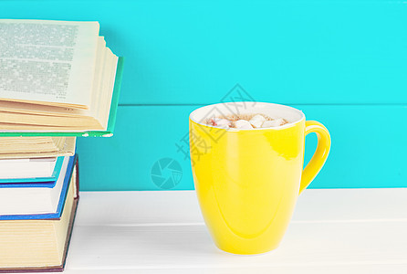 木制桌子上堆满的书和一杯茶咖啡文学精装教育学校字典智慧图书馆咖啡店书柜图片