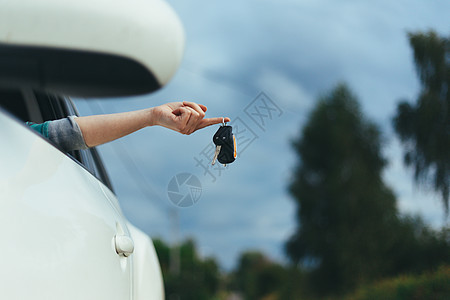 紧紧挂在女性手指上的车钥匙成人执照黑色白色司机销售汽车协议女孩成功图片