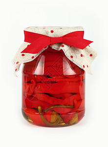 Jar 在白色的烂醉如泥的红辣椒玻璃丝带帆布乡村食物织物纺织品红色养护胡椒粉图片