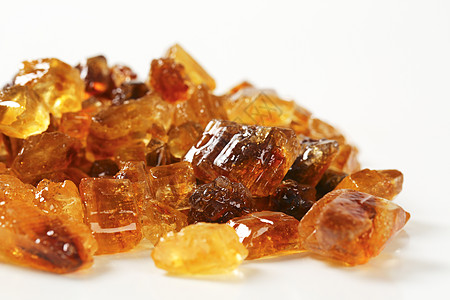 褐岩石糖琥珀色水晶味道焦糖肿块糖果团体食物棕色背景图片