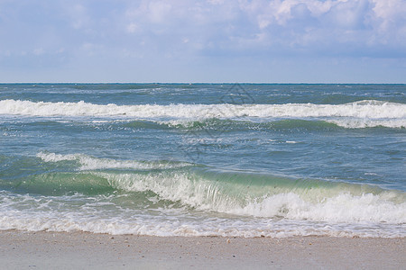 海滨海浪在沙滩上滚动 暴风日出图片