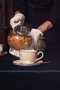 与海角泡茶治疗季节茶壶沙棘玻璃蜂蜜叶子饮料蓝色食物图片