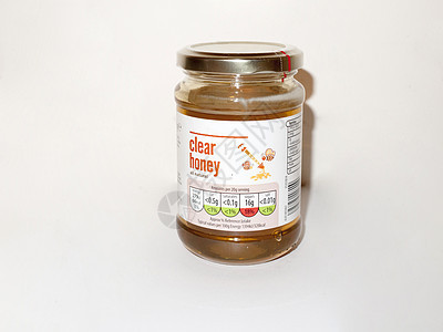 基本清洁蜂蜜白色背景食品工作室玻璃杯罐图片