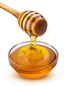蜂蜜和一碗满满的蜂蜜 孤立在白色背景上食物黄色滴水液体糖浆金子玻璃图片