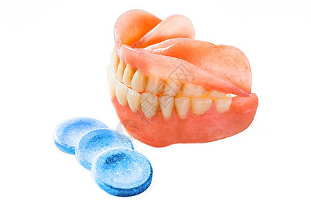 假牙和三片药片用于清洁图片