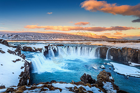 冰岛冬季日落时的戈达福斯瀑布岩石地标天空力量运动冰川溪流荒野流动旅行图片