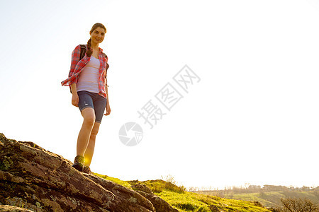 快乐女旅行家的肖像 背包站在松尼之夜的岩石上 旅行和冒险概念图片