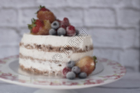 模糊的裸蛋糕与焦糖水果-草莓 蓝莓 覆盆子 花香高原海绵蛋糕 托盘 质朴的背景图片
