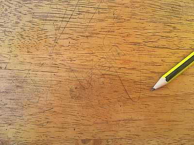 亮木地板上的绿色和黄色铅笔图片