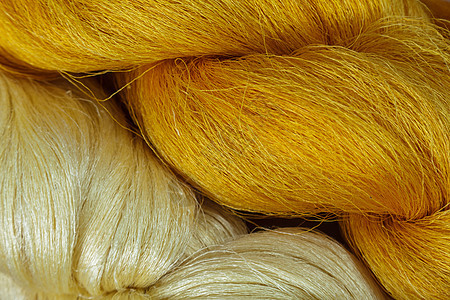 白色和黄色的蚕背景纤维宏观材料植物织物纺织品昆虫文化金子编织图片