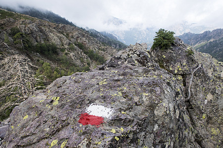 在岩石上作标记山脉旅行人行道冒险小路邮政旅游路线红色石头图片