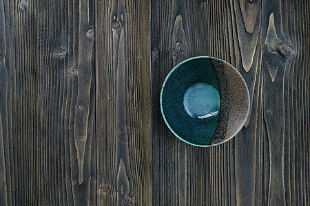 在木桌背景的空的陶瓷碗图片