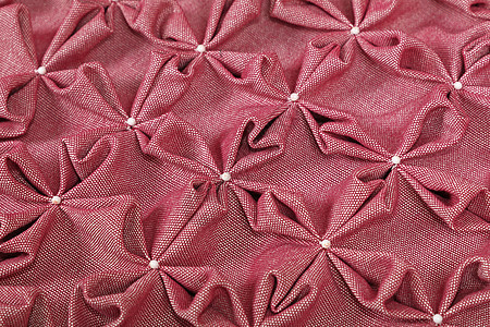 粉红色纺织粉扑的特写背景星星手工缝纫艺术软垫工作服刺绣纺织品风格罩衫图片