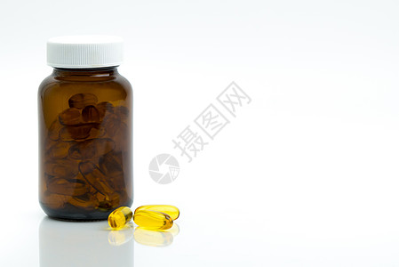 黄色鱼油胶囊丸 琥珀色玻璃瓶 桌上有空白标签 有文字复制空间 用于心脏保健和关节保健的维生素和补充剂 欧米茄 3 EPA 和 D背景图片