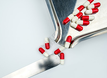 不锈钢药物托盘上红色 白色抗生素胶囊药丸的俯视图 耐药 抗生素用药合理 卫生政策和医保理念 医药行业 药房背景化学健康保险临床胶图片