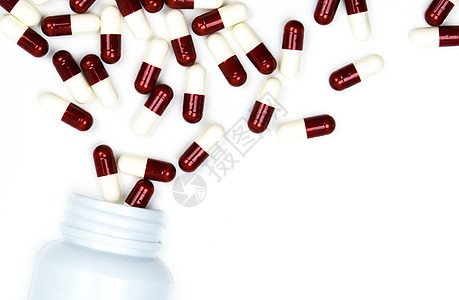 将抗生素胶囊丸倒入塑料瓶中 在白色背景下与复制空间隔离 药品储存 抗生素用药合理 卫生政策和医保理念创造力科学药物药片制药宏观临图片