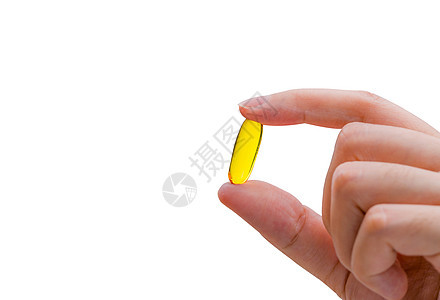 年轻妇女手握鱼油胶囊 妇女服用蛋白类3-3药丸 维生素和补充剂概念图片