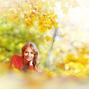 女人躺在秋叶上女性女孩森林微笑乐趣快乐红色金子金发橙子图片