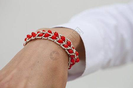 女性手上的红色红珠子手镯很时髦袖口女士串珠衣服手臂珠宝店铺女孩市场戒指图片