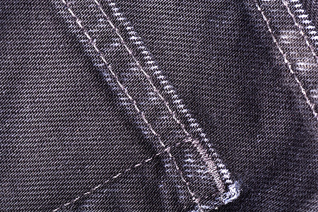 紧贴牛仔裤或衣物布料背景宏观服饰蓝色纺织品织物裤子材料黑色纤维靛青图片