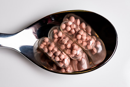 勺子上的平板电脑药品治愈止痛药胶囊科学白色药剂药物疼痛疾病图片