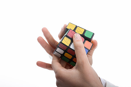 鲁比克的立方体在手绿色玩具智力方块红色游戏拼图形状魔方休闲背景图片