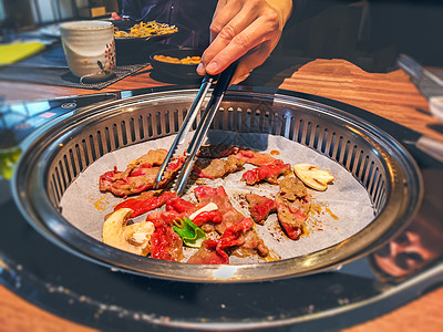 干锅鸡杂在餐桌上的烧烤炉里做咖哩茄泡菜烤牛肉背景