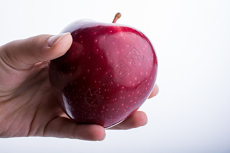 握着苹果的小小孩手绿色水果食物红色饮食白色图片