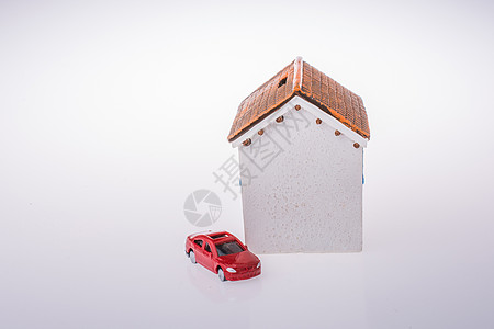 小模特儿房子和一辆红车背景图片