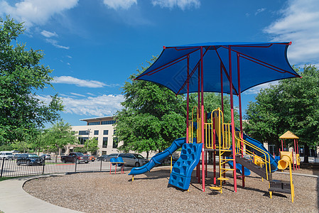 在德克萨斯州达拉斯附近的邻里游乐场 配有多彩结构设备力量健身房游戏天空童年锻炼公园玩具安全塑料图片