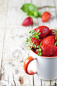 生锈木制木头b上白陶瓷杯中的有机红色红草莓制品浆果水果甜点园艺杯子收成早餐农场营养图片
