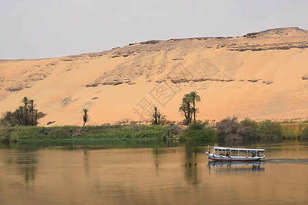 撒哈拉沙漠伊始 尼罗河位于阿斯旺埃及以尼罗河帆船占地的前方文化旅行地标植被树木岩石景观异国天空历史性图片