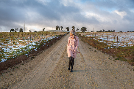 冬季在乡村公路上行走的妇女图片