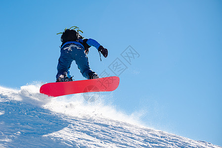 滑雪运动员在太阳尼日登上山峰红雪板 滑雪和冬季运动单板下坡季节假期速度滑雪板天空行动木板风镜图片