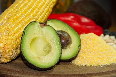 含有鳄梨和墨西哥其他食品原料的玉米饭小吃盘子玉米美食黄色桌子食物豆子营养面粉图片