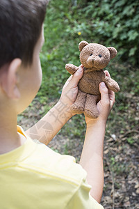 孩子手握着泰迪玩具婴儿男生孩子们童年女孩棕色图片