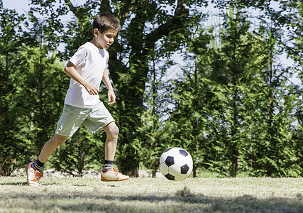 儿童在体育场踢足球游戏场地闲暇青年团队玩家男孩们公园孩子们水平图片