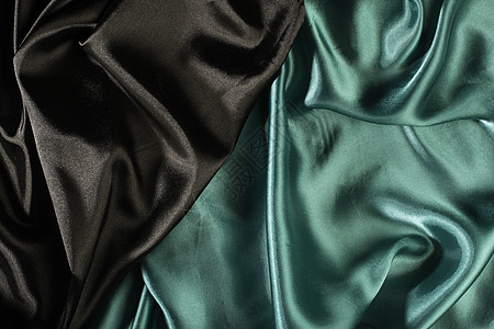 闪亮的黑色和绿色缎面面料材料布料衣服波浪状海浪纺织品曲线丝绸奢华图片