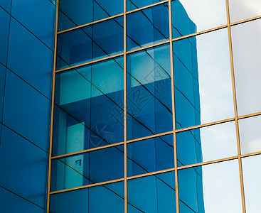 蓝色的办公大楼外墙窗面镜像窗口图片