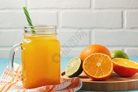 土制新鲜的橘子汁 在石匠罐中加压 橙子和石灰放在木盘缝合板上 复制空间图片
