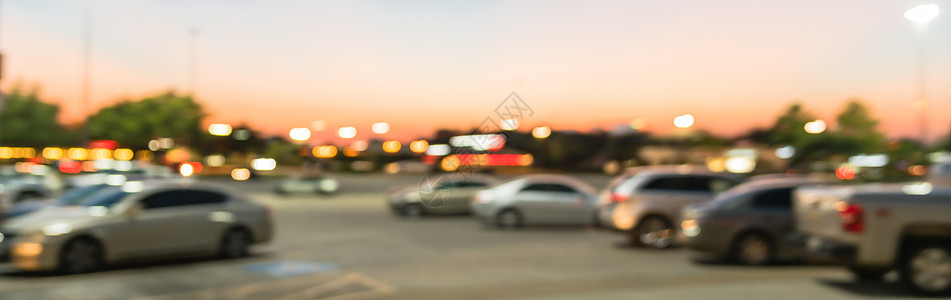 日落时在得克萨斯州休斯敦市购物商场停车场的全景模糊背景户外停车场娱乐车辆建造沥青商业零售建筑房地产标识出口图片