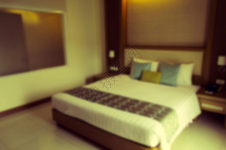 摘要模糊的卧室白色奢华房间酒店枕头家具背景图片