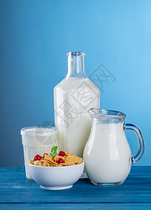 一杯牛奶和一罐装在格子桌布上的牛奶图片