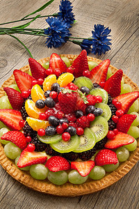 木木背景上的水果蛋糕美食桌子水果奶油十字糕点覆盆子奇异果橙子蛋糕图片