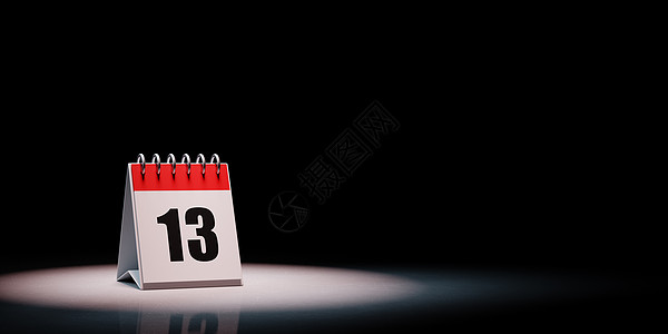 黑色背景上突出显示的日历第 1 天桌子红色白色点燃台历插图数字聚光灯图片